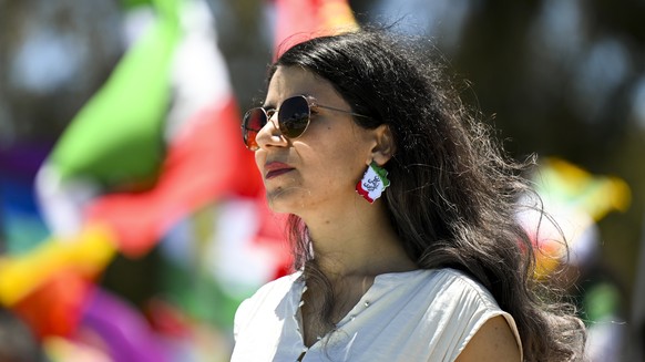 epa10333558 A demonstrator attends the Women Life Freedom protest in solidarity with citizens of Iran, outside Parliament House, in Canberra, Australia, 28 November 2022. After the death of Mahsa Amin ...
