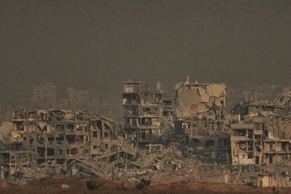 Buildings that were destroyed during the Israeli ground and air operations stand in the northern Gaza Strip, as seen from southern Israel, Thursday, Oct. 9, 2025, following the announcement that Israe ...
