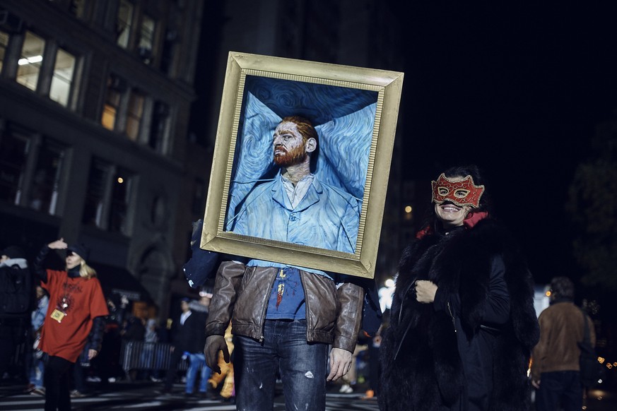 A reveler poses for the photographers during the Greenwich Village Halloween Parade, Tuesday, Oct. 31, 2017, in New York. (AP Photo/Andres Kudacki)