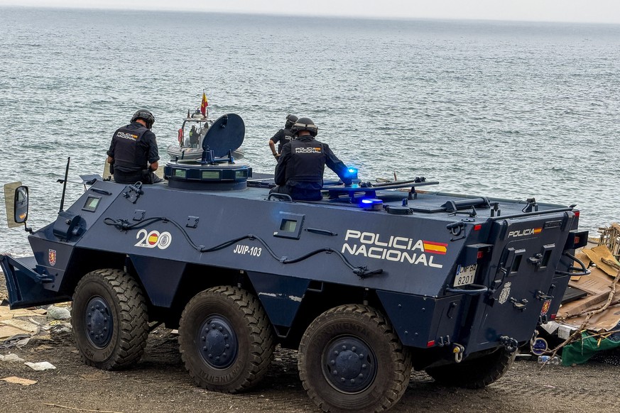 epa13282669 Members of the Spanish National Police ride an armoured vehicle during an operation to evict and dismantle the makeshift migrant encampment on Trampolin beach in Ceuta, Spain, 05 October 2 ...