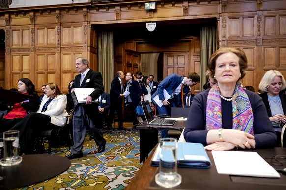 epa11266881 Nicaraguan Ambassador to the Netherlands Carlos Jose Arguello Gomez (C) arrives in the courtroom as Director General of Legal Affairs Tania von Uslar-Gleichen (R) of Germany looks on, duri ...