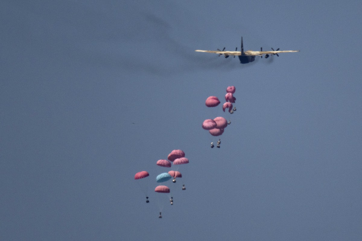 An aircraft airdrops humanitarian aid over northern Gaza Strip, as seen from southern Israel, Wednesday, March 20, 2024. (AP Photo/Leo Correa)