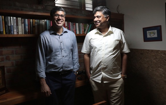 epa09494818 Ritwick Dutta (R) and Rahul Choudhary (L), Founders of environmental organization The Legal Initiative for Forest and Environment (LIFE), pose for a photograph at their office in New Delhi ...