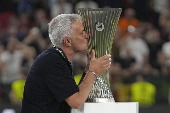 Roma's head coach Jose Mourinho, right, kisses the trophy at the end of the Europa Conference League final soccer match between AS Roma and Feyenoord at National Arena in Tirana, Albania, Wednesd ...