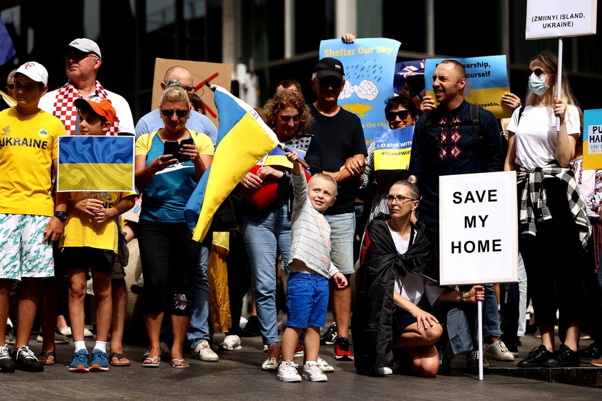 epa09788486 Protesters hold placards and flags during a rally against the war in Ukraine, in Sydney, New South Wales, Australia, 27 February 2022. Ukrainian Australians want more action from Australia ...