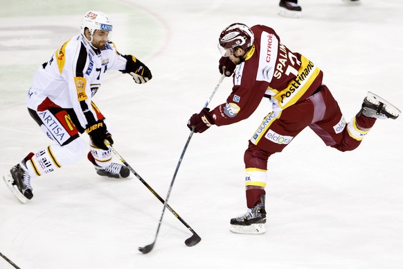 Geneve-Servette&#039;s forward Nick Spaling, of Canada, right, shoots the puck past Lugano&#039;s defender Philippe Furrer, left, during the game of National League A (NLA) Swiss Championship between  ...
