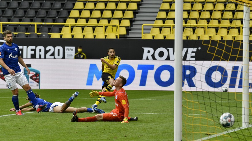 Dortmund&#039;s Raphael Guerreiro, background center, scores his side&#039;s second goal during the German Bundesliga soccer match between Borussia Dortmund and Schalke 04 in Dortmund, Germany, Saturd ...