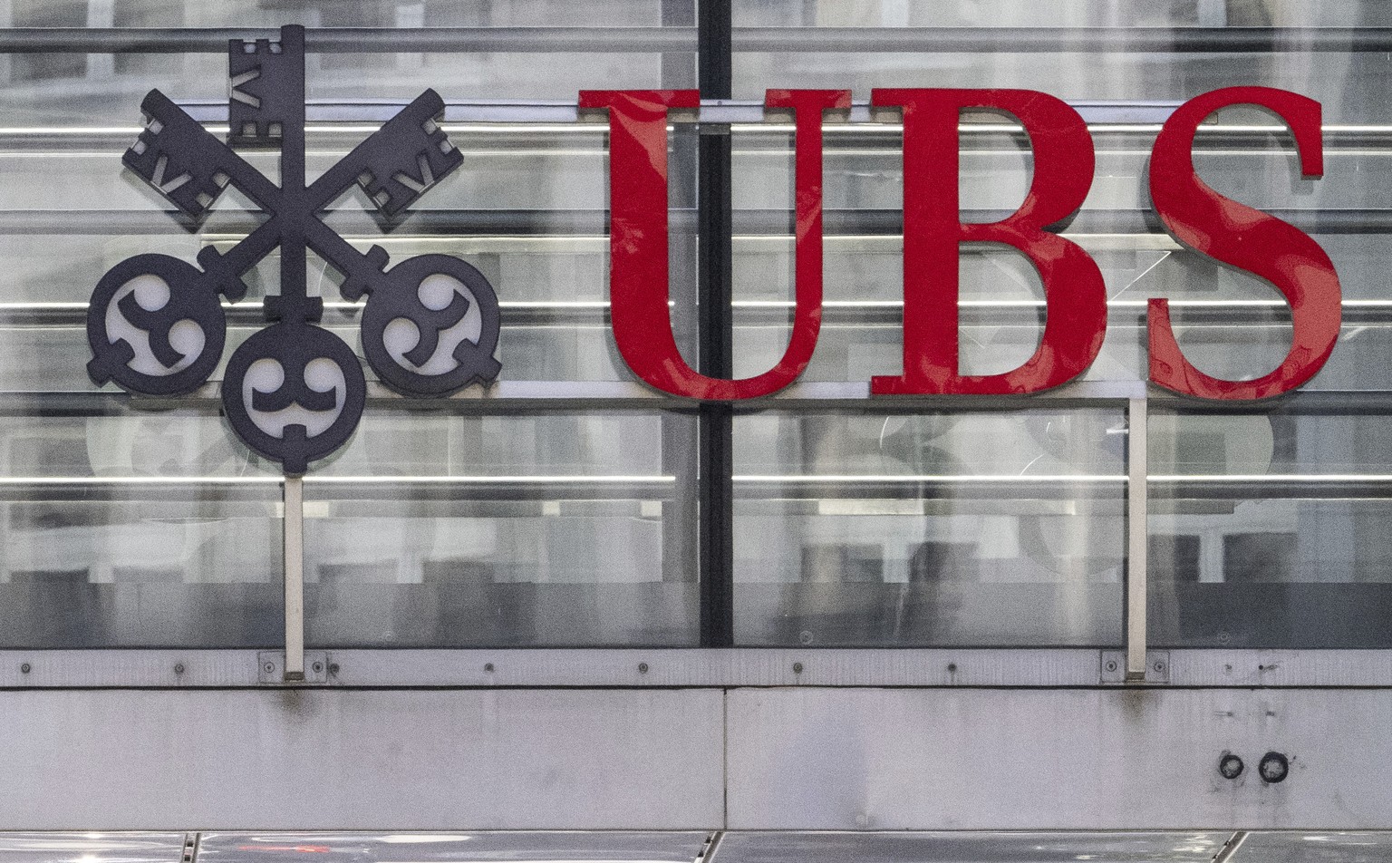 FILE - The logos of the Swiss banks Credit Suisse and UBS are pictured in Zurich, Switzerland, on June 12, 2023. UBS reported Tuesday Nov. 7, 2023 a $255 million pre-tax loss as the giant Swiss bank s ...