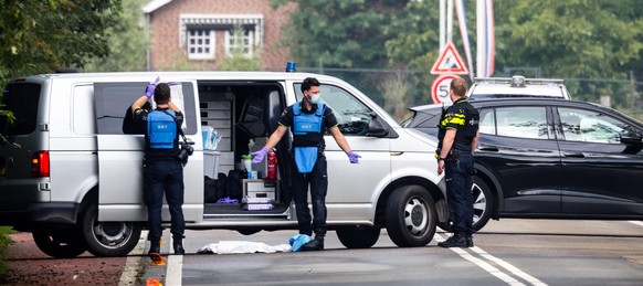 epa13204085 Police officers and forensic investigators work at the scene of a shooting along the Ewijkseweg in Overasselt, province of Gelderland, the Netherlands, 01 September 2026. One person died a ...