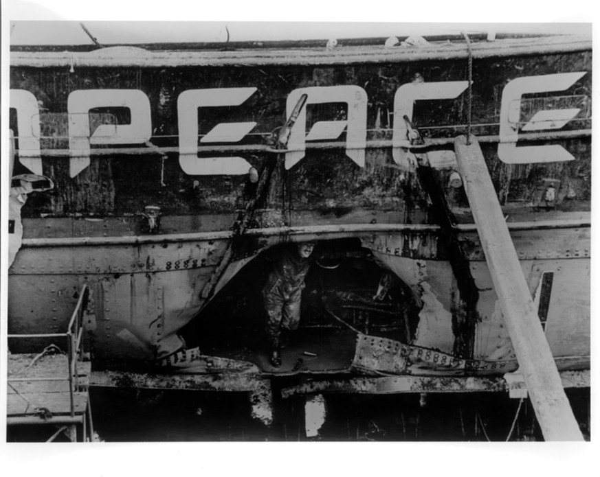 A gaping hole can be seen in the side of the Rainbow Warrior following the bombing by French secret service agents.