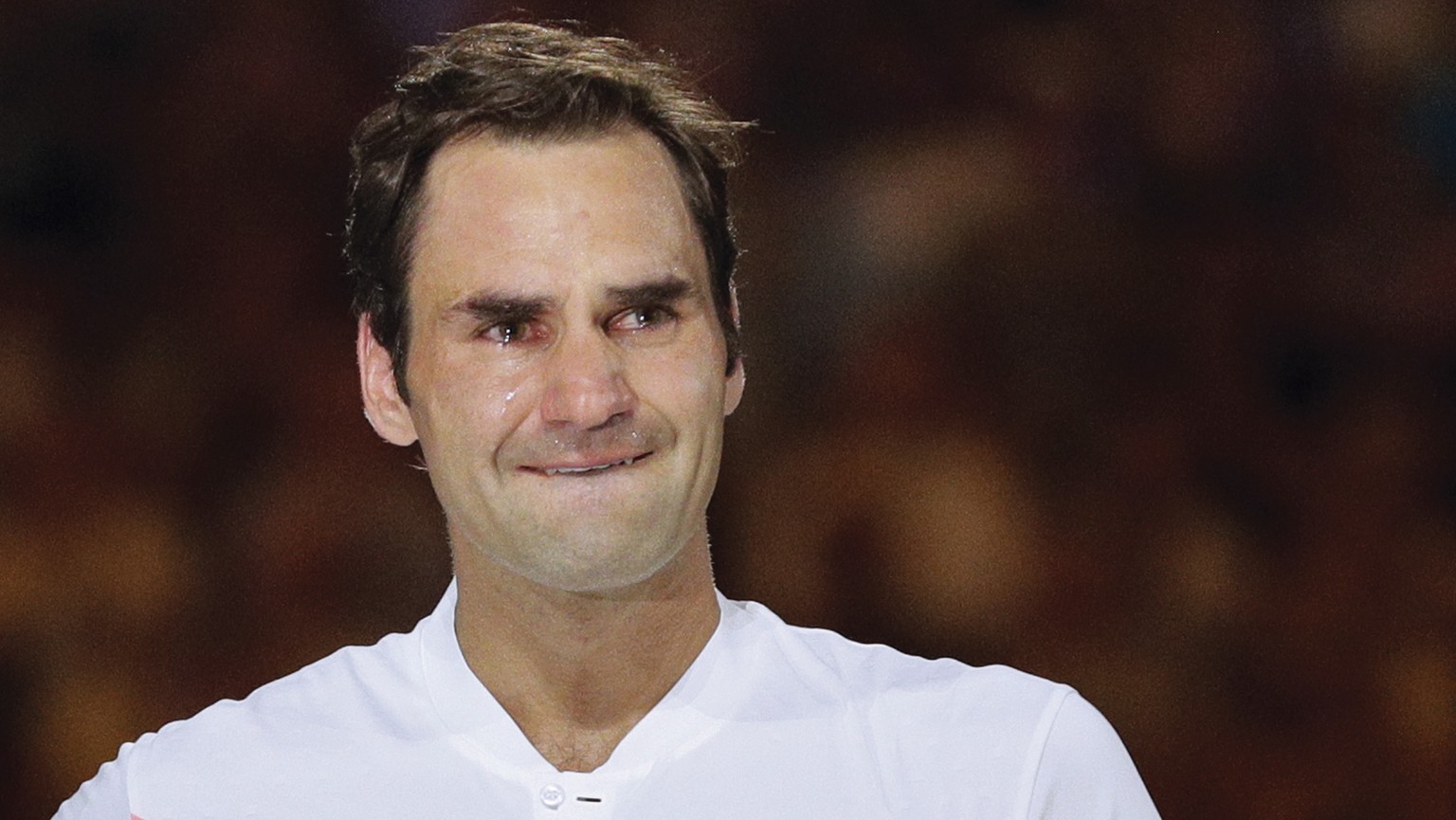 Switzerland&#039;s Roger Federer, right, has tears in his eyes as he holds his trophy after defeating Croatia&#039;s Marin Cilic during the men&#039;s singles final at the Australian Open tennis champ ...