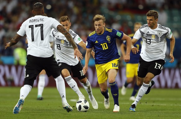 Sweden&#039;s Emil Forsberg, second from right, is tackled by Germany&#039;s Marco Reus, left, Joshua Kimmich, second from left, and Thomas Mueller during the group F match between Germany and Sweden  ...