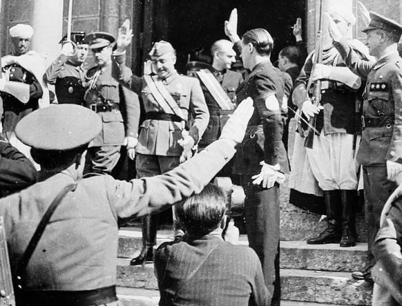Gen. Francisco Franco returns a salute as he leaves his headquarters following a reception he gave to members of a diplomatic corps in Burgos, Spain, Oct. 10, 1938, in celebration of the anniversary o ...