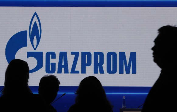 epa10185588 Participants in front of a large screen shows Gazprom Company before the plenary session ���Russian Gas Industry: Development Priorities in New Condition��� at the St. Petersburg Internati ...