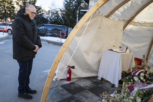 Swiss Federal Councillor Martin Pfister stands in silence in front of the memorial for the victims of the deadly fire at the "Le Constellation" bar in Crans-Montana, Switzerland, Sunday, Feb ...