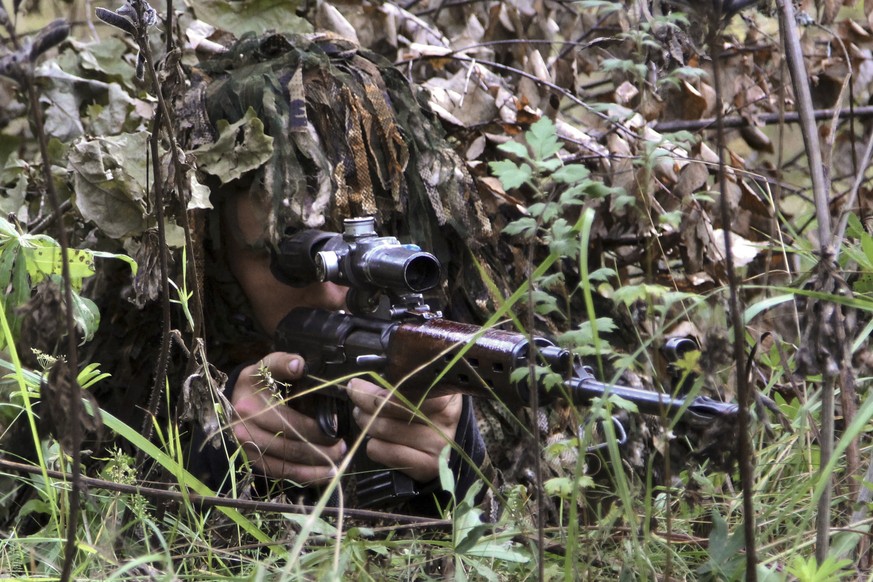 In this Saturday, Sept. 16, 2017 photo provided Sunday, Sept. 17, by Vayar Military Agency, a Belarus army soldier looks through his sniper rifle&#039;s optical device during a military exercise at a  ...