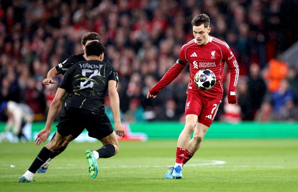epa12890225 Florian Wirtz (R) of Liverpool in action against Achraf Hakimi (L) of PSG during the UEFA Champions League quarter-finals, 2nd leg match Liverpool FC against Paris Saint-Germain, in Liverp ...