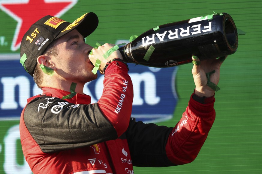 Ferrari driver Charles Leclerc of Monaco drinks champagne on the podium after winning the Australian Formula One Grand Prix in Melbourne, Australia, Sunday, April 10, 2022. (AP Photo/Asanka Brendon Ra ...