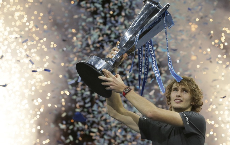Alexander Zverev of Germany holds up the trophy after defeating Novak Djokovic of Serbia in their ATP World Tour Finals singles final tennis match at the O2 Arena in London, Sunday Nov. 18, 2018. (AP  ...