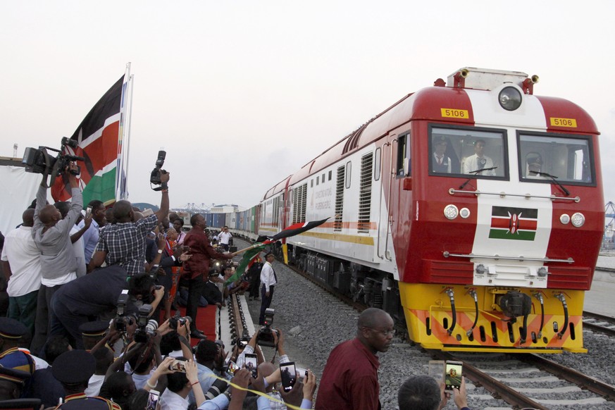 FILE - In this May 30, 2017, file photo, the SGR cargo train rides from the port containers depot on a Chinese-backed railway costing nearly $3.3 billion, opened by Kenya&#039;s president as one of th ...