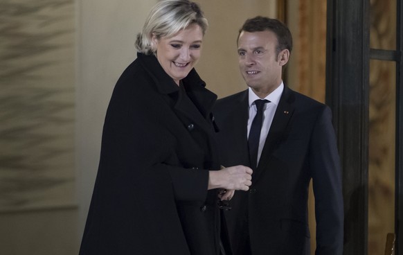 epa06342447 French President Emmanuel Macron (R) escorts far-right political party National Front (FN) president Marine Le Pen (L) after their meeting at the Elysee Palace in Paris, France, 21 Novembe ...