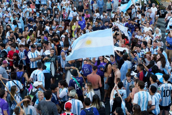 Buenos Aires, Argentina - December 4, 2022: Happy Argentine football fans celebrate winning a football match at the Qatar 2022 FIFA World Cup.