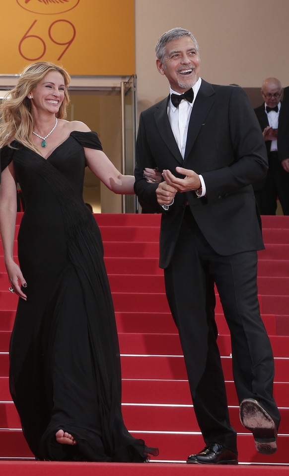 Actors Julia Roberts, left, and George Clooney pose for photographers for the screening of the film Money Monster at the 69th international film festival, Cannes, southern France, Thursday, May 12, 20 ...