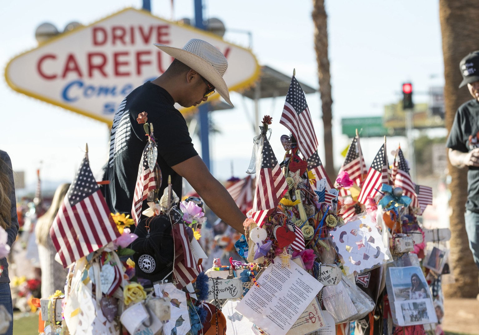 Route 91 Harvest shooting survivor Jason Zabala of San Diego, Calif., visits the memorial for victims of the Route 91 shooting at the &quot;Welcome to Fabulous Las Vegas&quot; sign, in Las Vegas, Frid ...