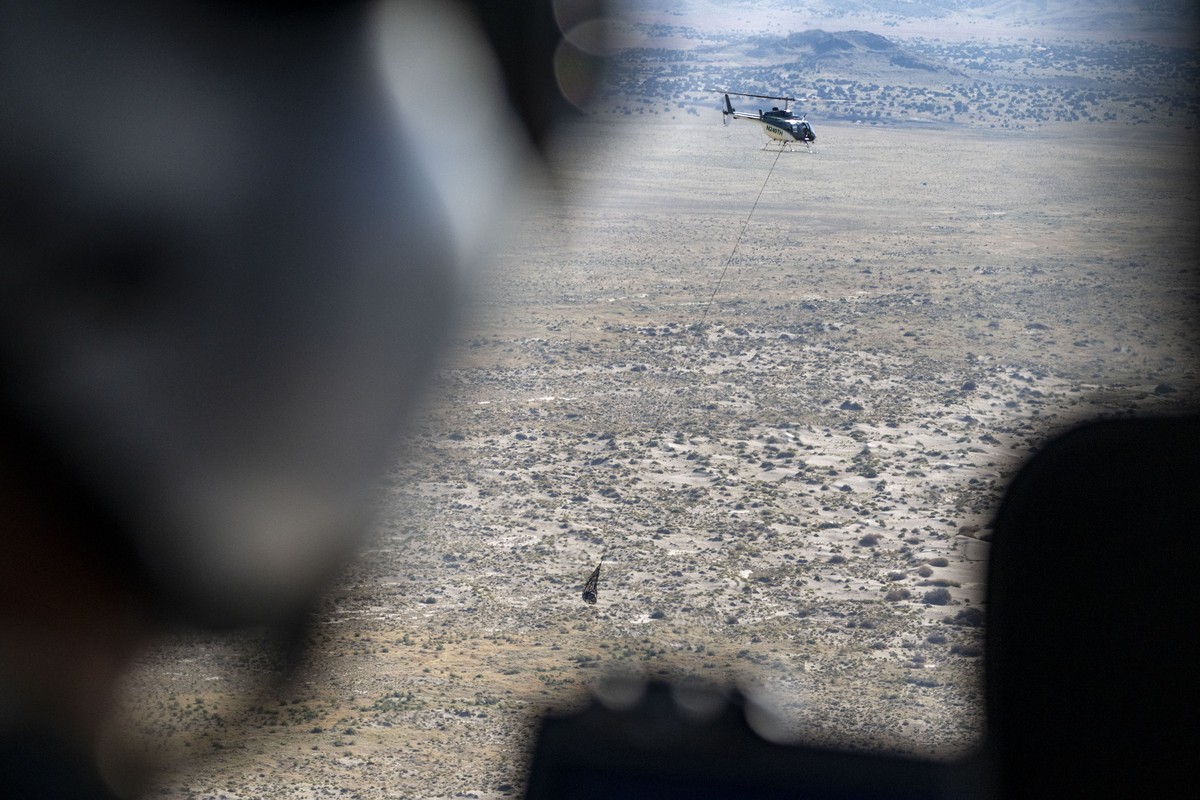 In this photo provided by NASA, the sample return capsule from NASA's Osiris-Rex mission is transported by helicopter after it landed at the Department of Defense's Utah Test and Training Ra ...