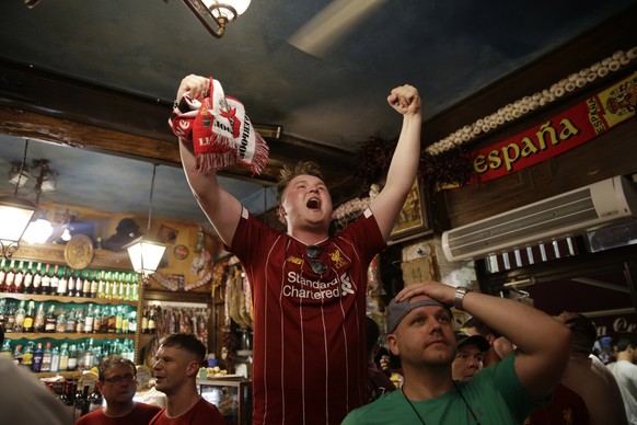 Liverpool supporters celebrate the victory in a pub at the final whistle of the Champions League final soccer match between Tottenham Hotspur and Liverpool at the Wanda Metropolitano Stadium in Madrid ...