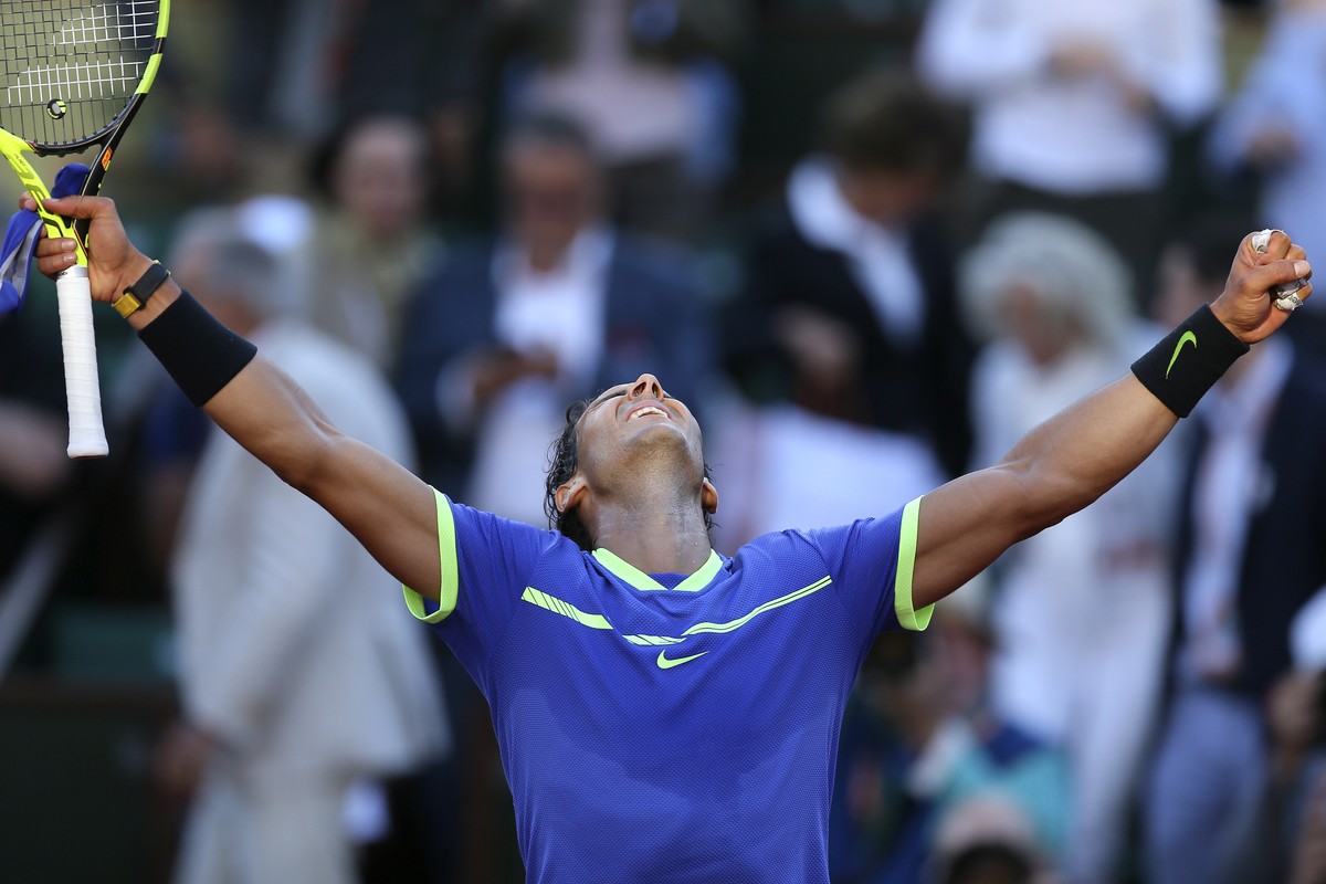Spain's Rafael Nadal raises his arms on victory after defeating Austria's Dominic Thiem during their semifinal match of the French Open tennis tournament at the Roland Garros stadium, Friday ...