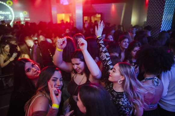People celebrate during the New Year&#039;s Eve party at Sektor11 night club in Zurich, Switzerland, early Saturday, January 1, 2022. Swiss government announced no new restrictions on Friday despite r ...