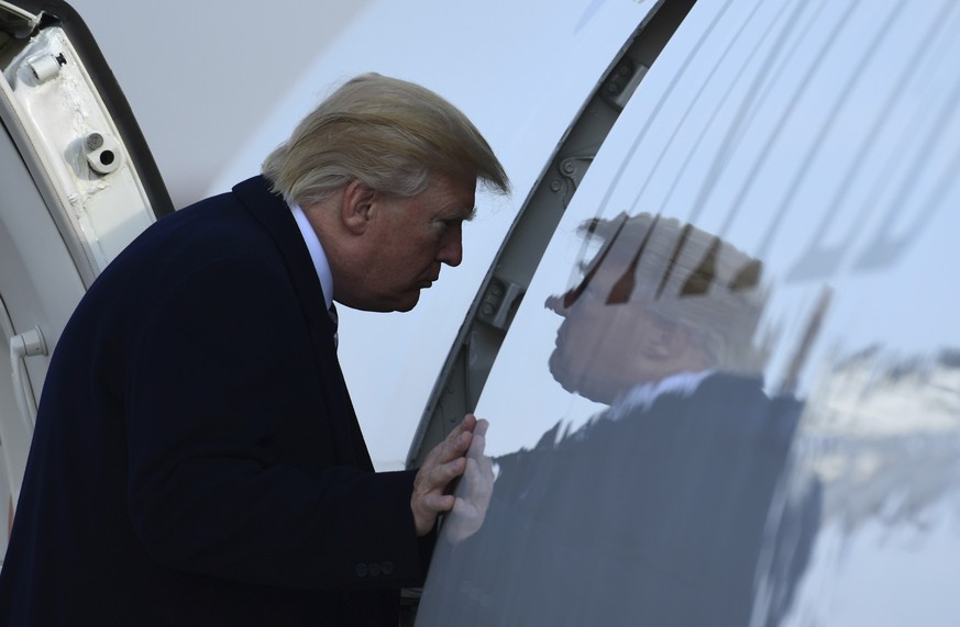 President Donald Trump walks up the steps of Air Force One at Andrews Air Force Base in Md., Saturday, Dec. 2, 2017. Trump is heading to New York to attend Republican fundraisers. (AP Photo/Susan Wals ...