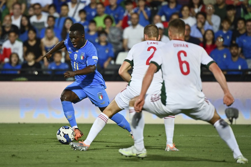 Italy&#039;s Wilfried Gnonto, left, vies for the ball with Hungary&#039;s Adam Lang and Willi Orban, during the UEFA Nations League soccer match between Italy and Hungary, at the Dino Manuzzi stadium  ...