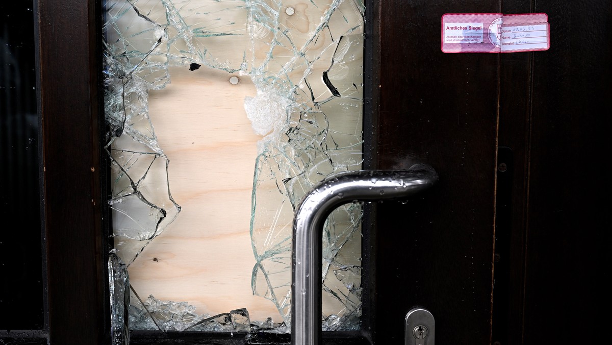 epa10513578 A police seal on the damaged door to the building that houses the Kingdom Hall of Jehovah's Witnesses, the day after a deadly shooting in Hamburg, Germany, 10 March 2023. According to ...