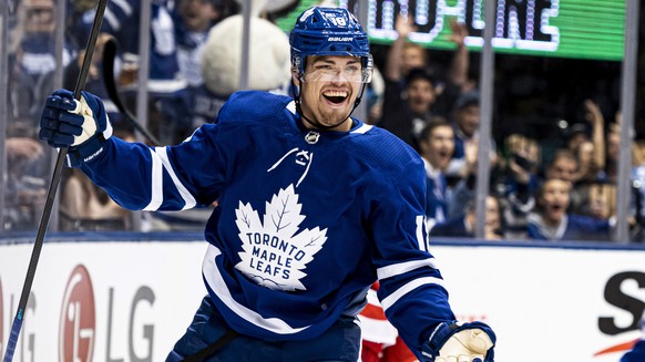 Toronto Maple Leafs left wing Andreas Johnsson (18) celebrates with center Auston Matthews (34) after Johnsson scored against the Detroit Red Wings during the first period of an NHL preseason hockey g ...