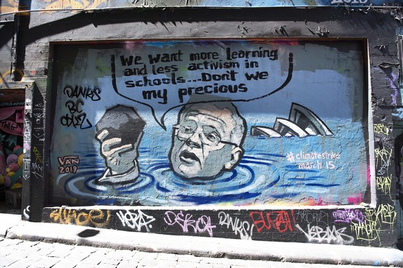 epa07412639 A view of a mural depicting Australian Prime Minister Scott Morrison in a flooded Sydney harbour holding a lump of coal, in Hosier Lane in Melbourne, Victoria, Australia, 04 March 2019. Th ...