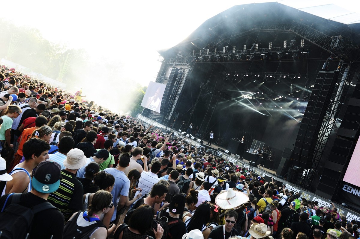 epa03779051 Festival goers attend the concert of French rap singer Kery James (rear C) at the 25th Eurockeennes Festival in Belfort, France, 06 July 2013. The music festival runs from 04 to 07 July. E ...