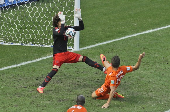 Mexico&#039;s goalkeeper Guillermo Ochoa makes a save after a shot by Netherlands&#039; Klaas-Jan Huntelaar during the World Cup round of 16 soccer match between the Netherlands and Mexico at the Aren ...