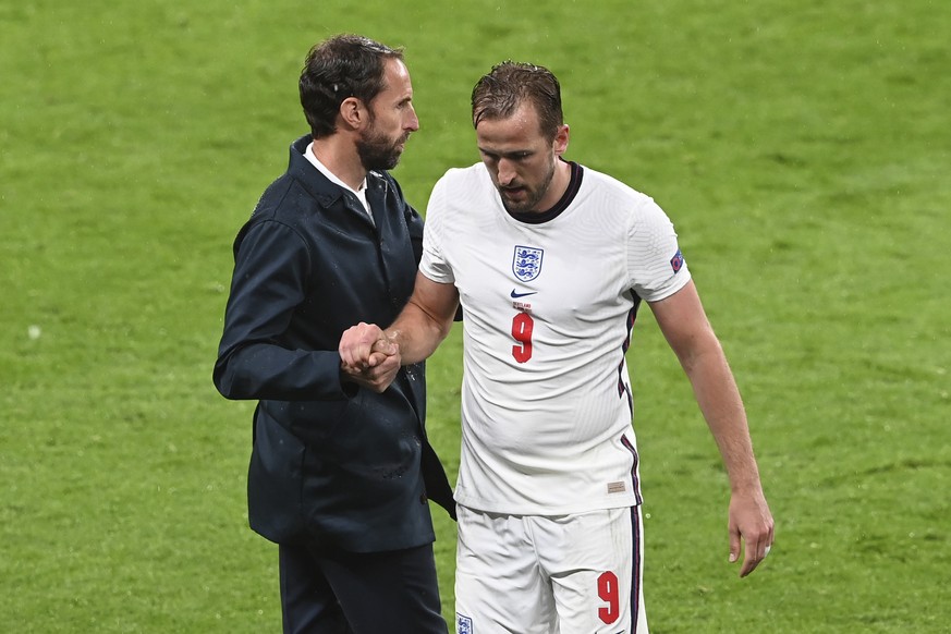 England&#039;s Harry Kane, right, shakes hands with his coach Gareth Southgate as he leaves the pitch during the Euro 2020 soccer championship group D match between England and Scotland, at Wembley st ...