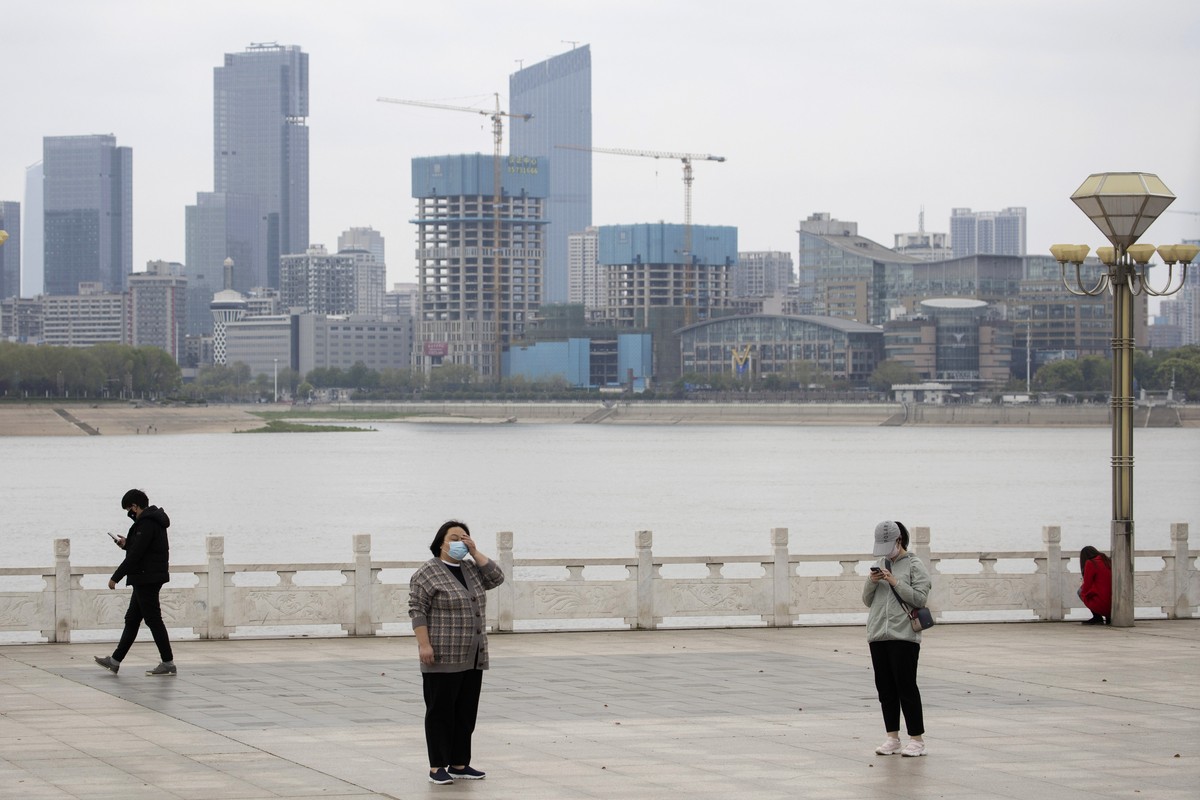 Residents observe social distancing at a park along the Yangtze River in Wuhan in central China's Wuhan province on Wednesday, April 1, 2020. Skepticism about ChinaÄôs reported coronavirus cases ...