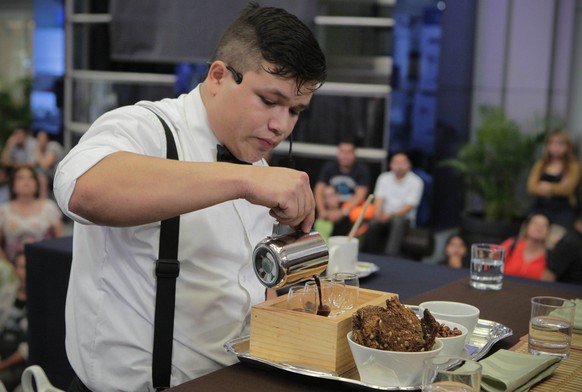 epa04657007 A barista prepares coffee during the eighth Salvadorean Championship of Barista in San Salvador, El Salvador, 10 March 2015. The Salvadorean Council of Coffee reduced by 25,63 percent its  ...