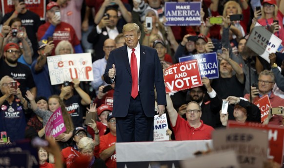 President Donald Trump gives a thumbs up before speaking at a campaign rally, Monday, Nov. 5, 2018, in Cleveland. (AP Photo/Tony Dejak)