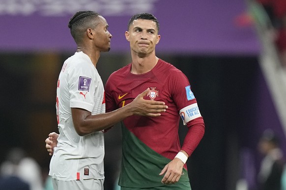 Portugal's Cristiano Ronaldo cheers with Switzerland's Manuel Akanji at the end of the World Cup round of 16 soccer match between Portugal and Switzerland, at the Lusail Stadium in Lusail, Qatar, Tues ...