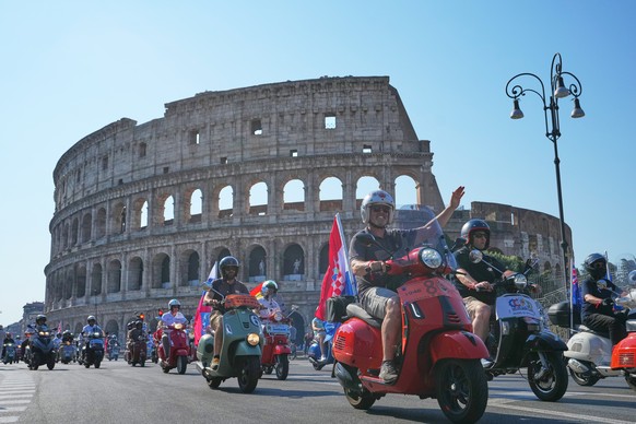 Vespa enthusiasts parade in front of the Colosseum during celebrations for the 80th anniversary of the Vespa scooter, in Rome, Saturday, June 27, 2026. (AP Photo/Alessandra Tarantino)
Italy Vespa 80th ...