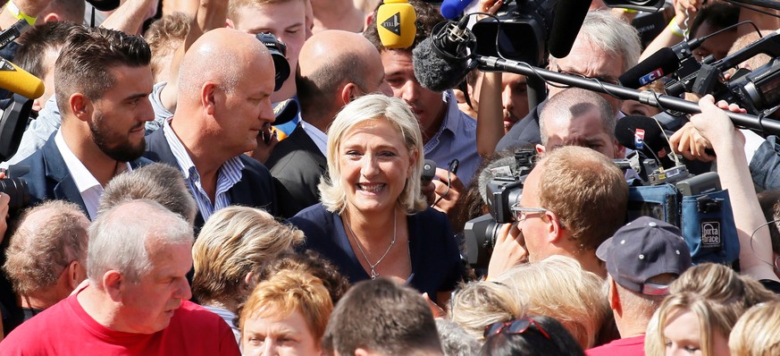 Marine Le Pen, French National Front (FN) political party leader and a member of the European Parliament, leaves after attending a FN political rally in Brachay, France, September 3, 2016. REUTERS/Gon ...