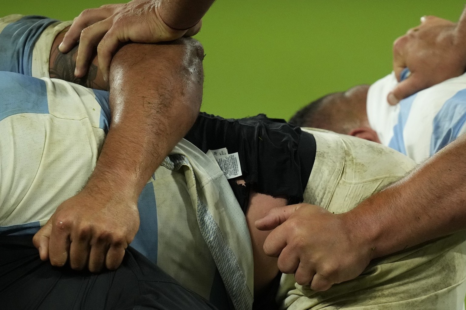 Hands grapple in a ruck during the Rugby World Cup semifinal match between Argentina and New Zealand at the Stade de France in Saint-Denis, outside Paris, Friday, Oct 20, 2023. (AP Photo/Christophe En ...
