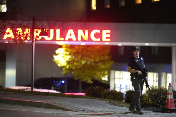 A law enforcement officer carries a rifle outside Central Maine Medical Center during an active shooter situation in Lewiston, Maine, Wednesday, October 8.  25, 2023. (AP Photo/Steven Senne)