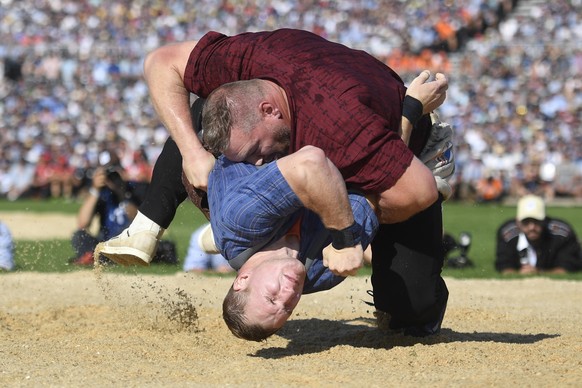 epa07793155 Christian Stucki (top) wins against Joel Wicki during the Swiss Alpine Wrestling and Herdsman Festival 2019 in Zug, Switzerland, 25 August 2019. The Federal Alpine Wrestling Festival takes ...