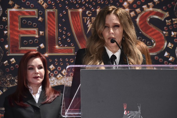 Priscilla Presley, former wife of the late singer Elvis Presley, left, looks on as her daughter Lisa Marie Presley, speaks during a hand and footprint ceremony in their honor on Tuesday, June 21, 2022 ...